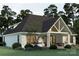 Expansive rear exterior with a covered patio and ample seating for entertaining or relaxing at 1807 Kennesaw Dr, Charlotte, NC 28216
