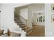 Elegant staircase with wooden steps, iron railings, and natural light streaming in from nearby windows at 1807 Kennesaw Dr, Charlotte, NC 28216