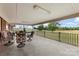 This open back porch features concrete flooring, a white railing, and comfortable chairs that offer a great view of the yard at 1870 Sloan Rd, Mt Ulla, NC 28125