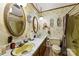 Vintage bathroom boasts a double vanity with gold fixtures and ample counter space at 1870 Sloan Rd, Mt Ulla, NC 28125