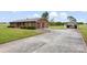 Exterior angle showcasing the brick home with two-car garage and a large detached garage with ample driveway space at 1870 Sloan Rd, Mt Ulla, NC 28125