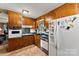 Efficient kitchen layout with wooden cabinets and practical appliances at 1870 Sloan Rd, Mt Ulla, NC 28125