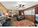 Warm living room with wood paneling and a stone fireplace at 1870 Sloan Rd, Mt Ulla, NC 28125