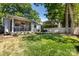 Expansive backyard features a screened in porch and an outdoor living area with a stone patio at 2033 Charlotte Dr, Charlotte, NC 28203