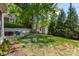 Large backyard with a small shed, outdoor dining area, patio and plenty of shade at 2033 Charlotte Dr, Charlotte, NC 28203