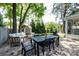 Charming backyard patio with outdoor dining, a cozy seating area and lush landscaping at 2033 Charlotte Dr, Charlotte, NC 28203