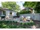 Outdoor living on stone patio with dining area, grilling space, and cushioned seating at 2033 Charlotte Dr, Charlotte, NC 28203