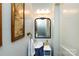 Quaint powder room with a unique vanity, decorative mirror, and elegant lighting at 2033 Charlotte Dr, Charlotte, NC 28203