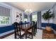 Elegant dining room showcasing blue accents, statement lighting, and ample natural light at 2033 Charlotte Dr, Charlotte, NC 28203
