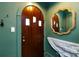 Beautiful entryway featuring dark wood door and gold-framed mirror at 2033 Charlotte Dr, Charlotte, NC 28203