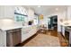 Well-lit kitchen featuring white cabinetry, stainless appliances, and an adjacent breakfast nook at 2033 Charlotte Dr, Charlotte, NC 28203