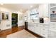 Bright kitchen with white cabinets, stainless steel appliances, and hardwood floors at 2033 Charlotte Dr, Charlotte, NC 28203