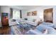 Cozy living room with large sectional couch, bright lighting, and hardwood floors at 2033 Charlotte Dr, Charlotte, NC 28203