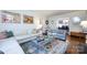 Bright living room featuring a white sofa, stylish decor, and views into the dining room at 2033 Charlotte Dr, Charlotte, NC 28203