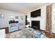 Bright living room featuring a fireplace, large windows, and comfortable seating at 2033 Charlotte Dr, Charlotte, NC 28203