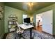Bright home office with modern furniture, ample lighting, and access to the kitchen at 2033 Charlotte Dr, Charlotte, NC 28203