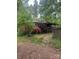 Charming single-story home nestled in a lush, wooded setting with a covered front porch and inviting curb appeal at 208 James Dr, Cleveland, NC 27013