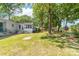 Spacious backyard featuring a well-maintained lawn, mature trees, patio, and swing at 22330 Torrence Chapel Rd, Cornelius, NC 28031