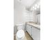 Bathroom showcasing a vanity, granite countertop, and shelved storage at 22330 Torrence Chapel Rd, Cornelius, NC 28031