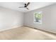 This bedroom is bright and spacious with a window and ceiling fan at 22330 Torrence Chapel Rd, Cornelius, NC 28031