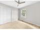 Comfortable bedroom featuring a ceiling fan, closet, neutral walls, and carpeted floors at 22330 Torrence Chapel Rd, Cornelius, NC 28031