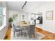 Bright dining room featuring hardwood floors, natural light, and a view into the kitchen at 22330 Torrence Chapel Rd, Cornelius, NC 28031