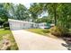 Charming home featuring a long driveway, lush landscaping, and attached garage at 22330 Torrence Chapel Rd, Cornelius, NC 28031