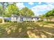 Charming white brick home with a bright blue door and lush green lawn and landscaped front yard at 22330 Torrence Chapel Rd, Cornelius, NC 28031