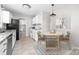Eat-in kitchen features white cabinets, granite countertops and stainless steel appliances at 22330 Torrence Chapel Rd, Cornelius, NC 28031