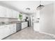 Spacious kitchen featuring white cabinets, stainless steel appliances, granite countertops, and tile floors at 22330 Torrence Chapel Rd, Cornelius, NC 28031