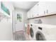 Functional laundry room with washer, dryer, and ample storage space at 22330 Torrence Chapel Rd, Cornelius, NC 28031