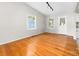 Bright living room featuring hardwood floors, neutral walls, and natural light from two windows at 22330 Torrence Chapel Rd, Cornelius, NC 28031