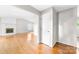 Spacious living area with hardwood floors, light gray walls, and a white brick fireplace at 22330 Torrence Chapel Rd, Cornelius, NC 28031
