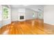 Open living area with hardwood floors, a brick fireplace, large windows, and neutral paint at 22330 Torrence Chapel Rd, Cornelius, NC 28031
