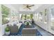 A cozy sunroom featuring many windows with views of the outdoors, with comfortable seating at 22330 Torrence Chapel Rd, Cornelius, NC 28031