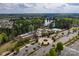 The aerial view features the community center, pool, landscaping, parking, and a scenic lake in the background at 23147 Whimbrel Cir, Fort Mill, SC 29707