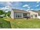 Backyard with a well-maintained lawn, screened porch, and patio area, perfect for outdoor enjoyment at 23147 Whimbrel Cir, Fort Mill, SC 29707