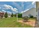 Spacious backyard with a brick patio set for outdoor dining, surrounded by lush greenery at 23147 Whimbrel Cir, Fort Mill, SC 29707