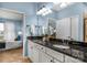 Bathroom with granite countertop and white cabinetry, complemented by a view into a bedroom at 23147 Whimbrel Cir, Fort Mill, SC 29707