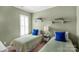 Cozy bedroom with twin beds, shelving, and bright window light for a cheerful space at 23147 Whimbrel Cir, Fort Mill, SC 29707