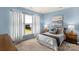 Comfortable bedroom with a well-lit window, soft blue walls, and cozy decor for relaxation at 23147 Whimbrel Cir, Fort Mill, SC 29707