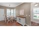 Charming breakfast nook with a round table, natural light from shuttered windows, and a decorative cabinet at 23147 Whimbrel Cir, Fort Mill, SC 29707