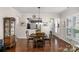 View of a dining room with hardwood floors and an adjacent kitchen area, offering a welcoming space for meals at 23147 Whimbrel Cir, Fort Mill, SC 29707
