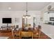 Inviting dining space with hardwood floors, a classic chandelier, and an open view to the kitchen at 23147 Whimbrel Cir, Fort Mill, SC 29707