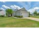 Charming single-story home with a well-manicured lawn, tidy landscaping, and a two-car garage at 23147 Whimbrel Cir, Fort Mill, SC 29707