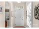 Bright foyer with a white front door, transom window, and stylish decorative accents at 23147 Whimbrel Cir, Fort Mill, SC 29707