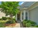 Charming front entrance with a decorative wreath, bay window, and tidy, trimmed landscaping at 23147 Whimbrel Cir, Fort Mill, SC 29707