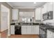 Modern kitchen featuring white cabinets, black appliances, and granite countertops for a sleek design at 23147 Whimbrel Cir, Fort Mill, SC 29707