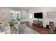 Cozy living room featuring hardwood floors, an area rug, and ample natural light at 23147 Whimbrel Cir, Fort Mill, SC 29707