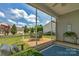 Enjoy the outdoors from this screened-in patio with comfortable seating and serene backyard views at 23147 Whimbrel Cir, Fort Mill, SC 29707